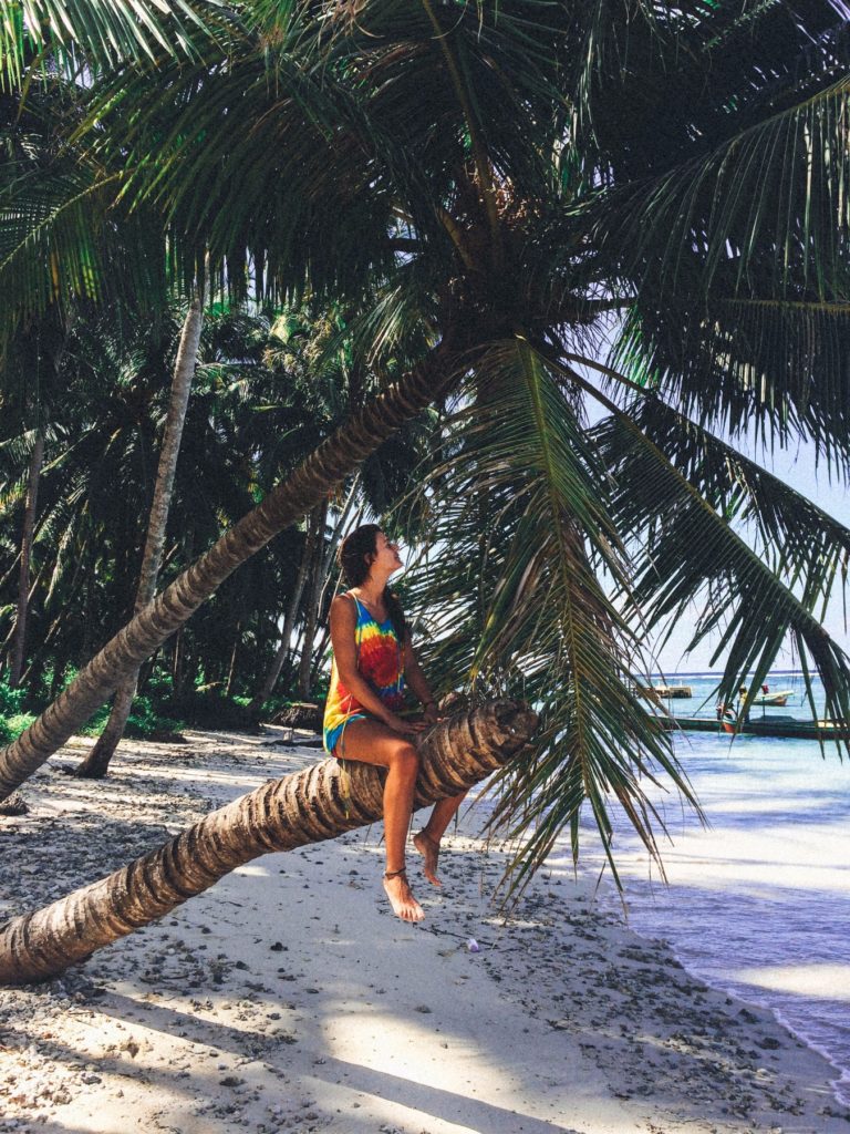 A girl sitting on coconut palm