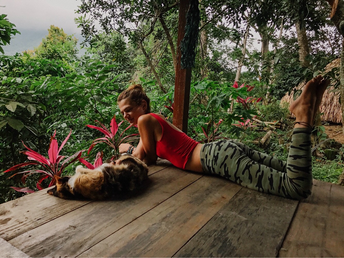 A girl lying with a cat in Minca