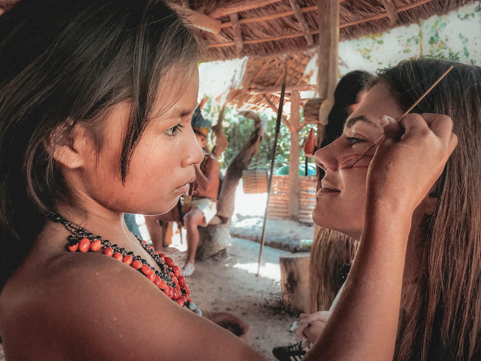 A little girl from Amazonia making a tattoo face