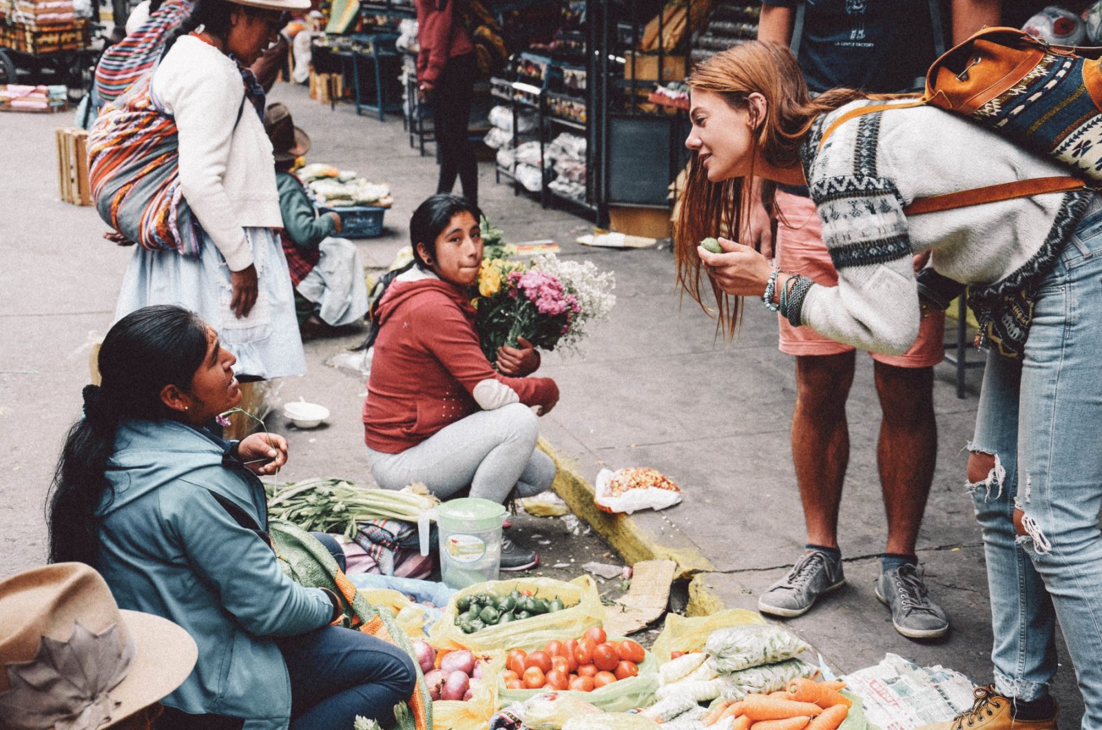 A girl talking to the Peruvian seller at the market