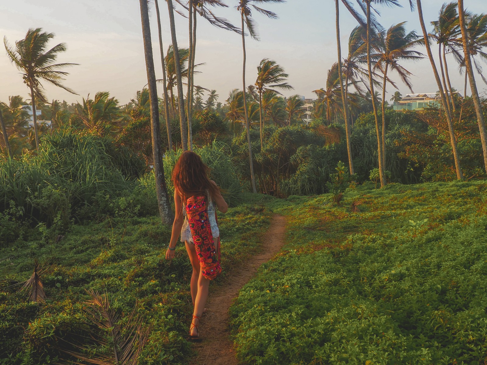 A girl walking to the sunset point in Mirissa
