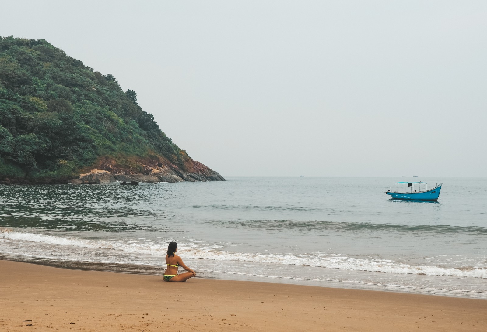 Girl meditating on the Kudle beach in Gokarna