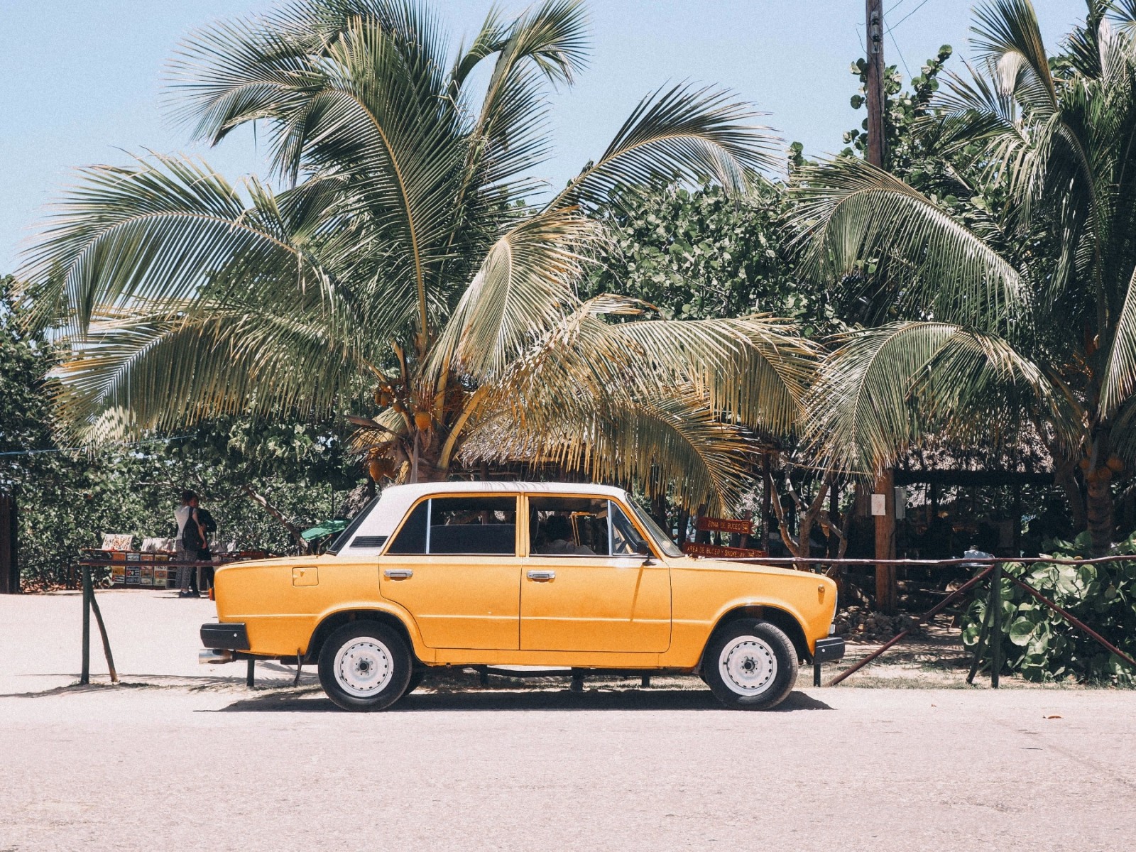A yellow small Cuban car