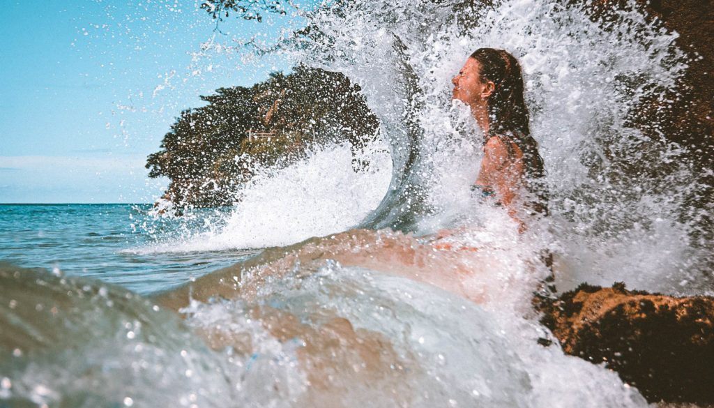 Girl Letting Wave Splash On Face