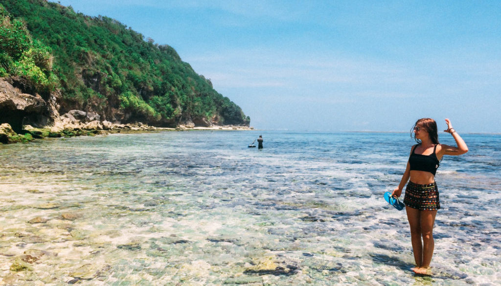 Girl standing in the water and enjoying the Sun