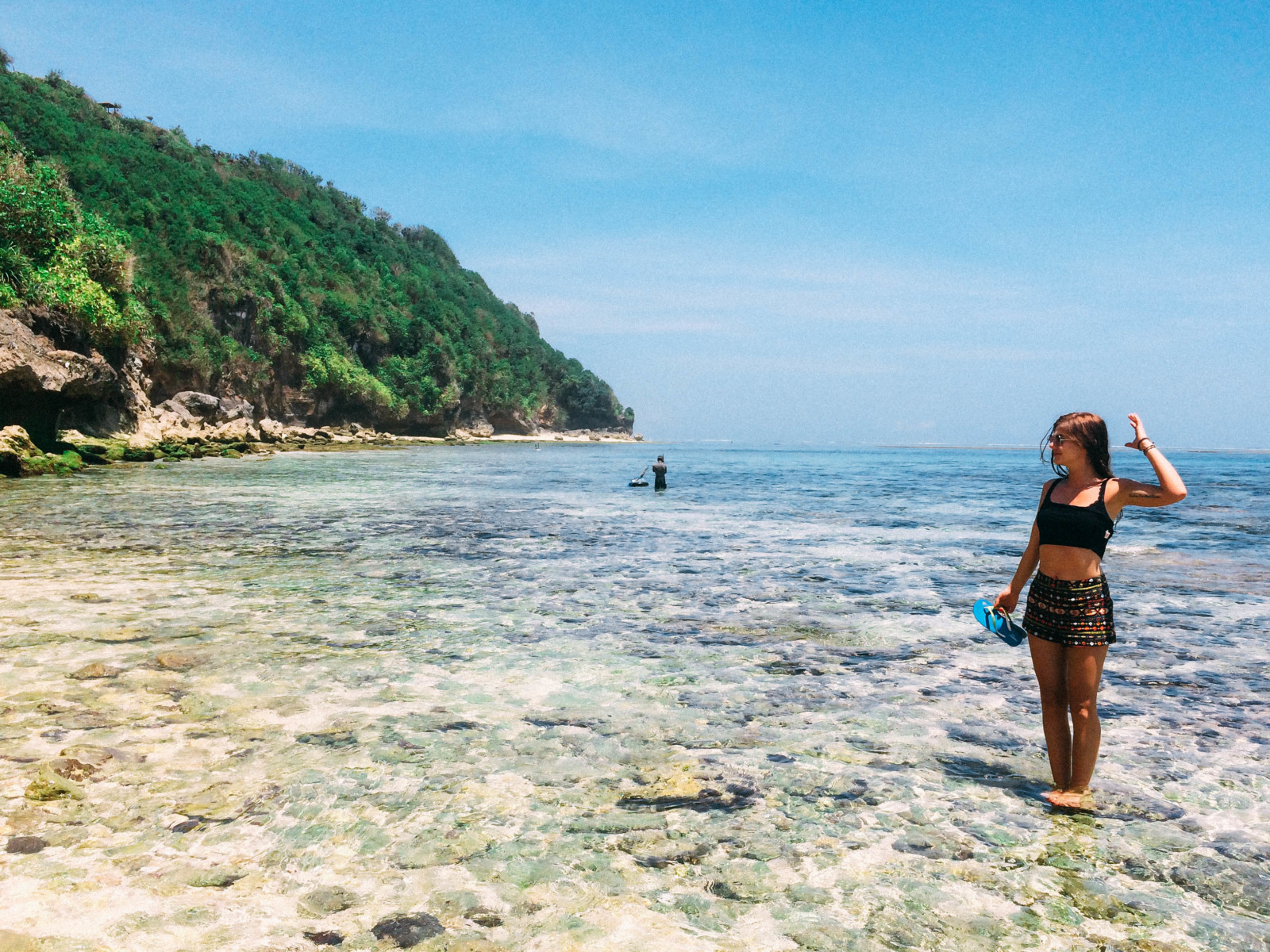 Girl standing in the water and enjoying the Sun