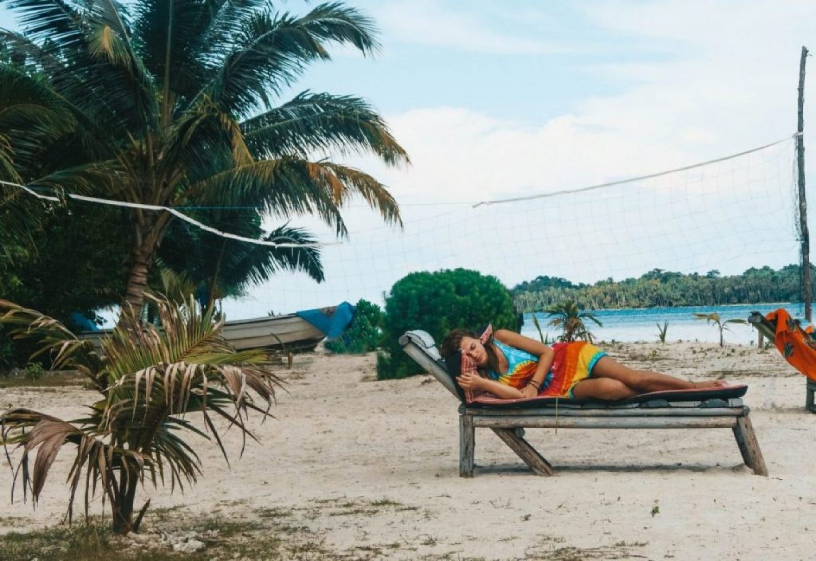 A girl sleeping on a deck chair on the beach