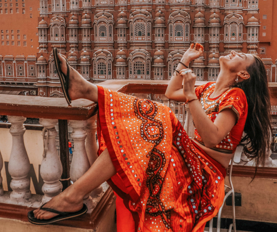 a girl sitting in the front of the Hawa Mahal