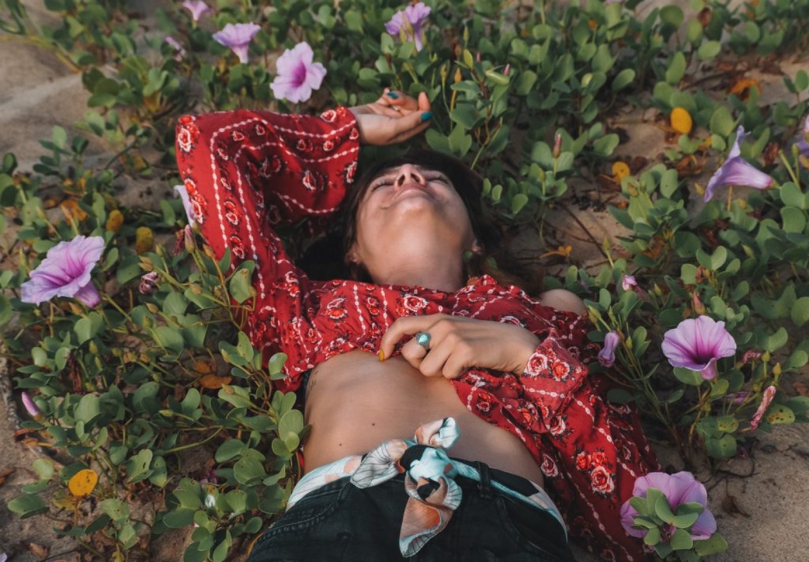 a girl lying in flowers