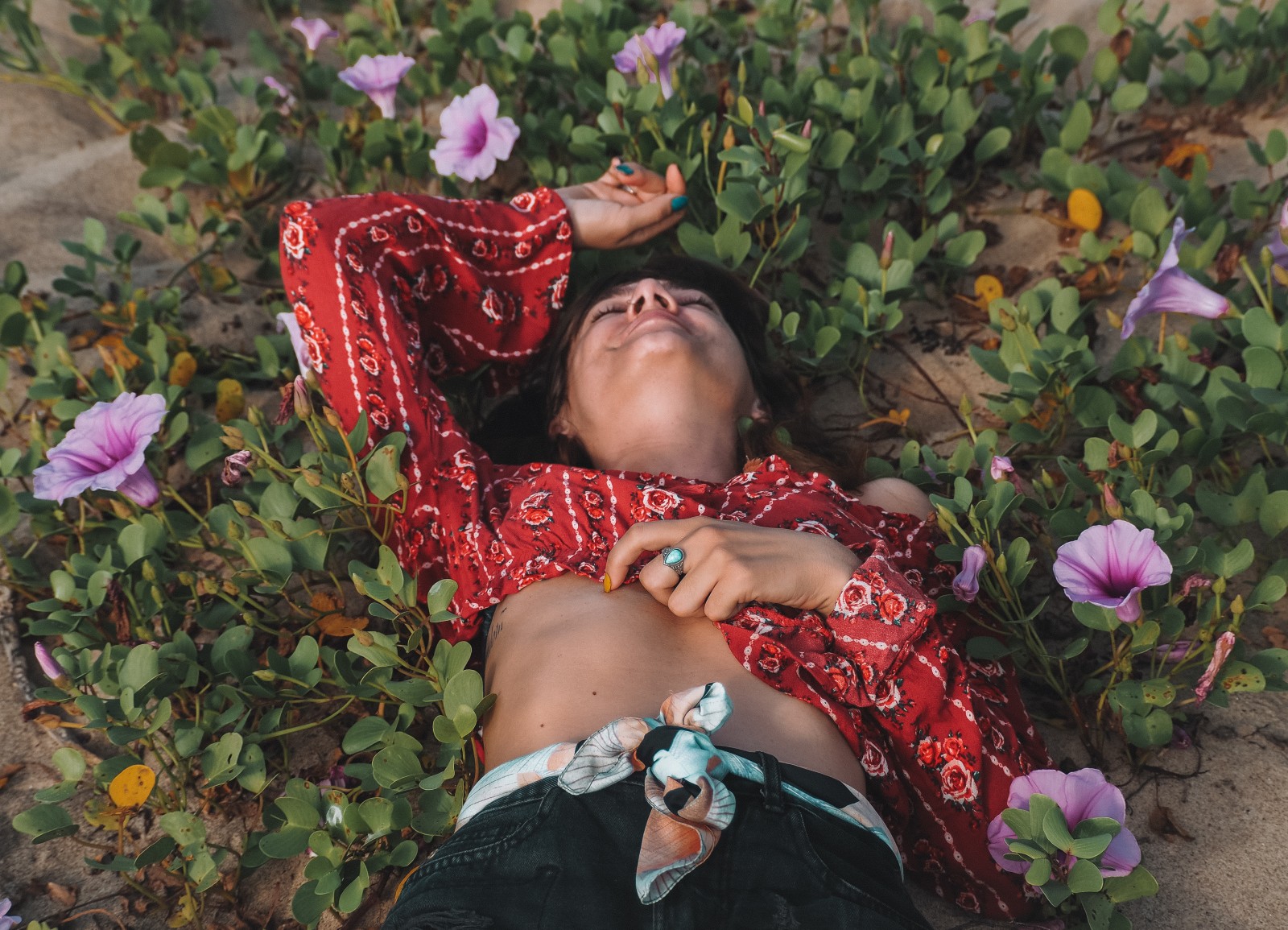 a girl lying in flowers