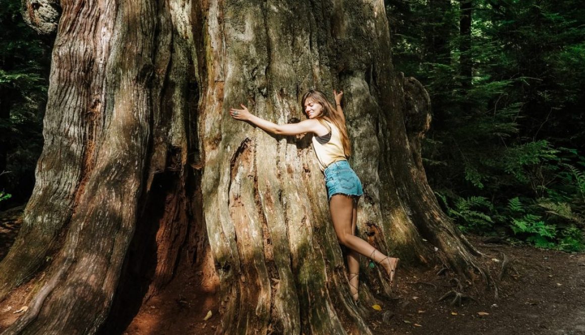 a girl hugging a tree